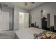 Comfortable bedroom with a walk-in closet, soft grey walls, and a cityscape mural at 15655 W Berkeley Rd, Goodyear, AZ 85395