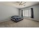 Spacious bedroom with neutral walls, carpet flooring, and a ceiling fan for added comfort at 15655 W Berkeley Rd, Goodyear, AZ 85395