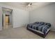 Bedroom with carpet flooring, a ceiling fan, neutral walls, and an open doorway at 15655 W Berkeley Rd, Goodyear, AZ 85395