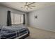 Bedroom with soft carpet flooring, window, and mounted TV bracket on the wall at 15655 W Berkeley Rd, Goodyear, AZ 85395