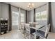 Dining area featuring a wooden table, chair set, and plenty of natural light from the large windows at 15655 W Berkeley Rd, Goodyear, AZ 85395