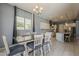 Bright dining area with white cabinets, a dining table set, and seamless flow to the kitchen at 15655 W Berkeley Rd, Goodyear, AZ 85395