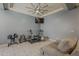 Well-equipped exercise room with modern ceiling fan, TV, and comfortable seating at 15655 W Berkeley Rd, Goodyear, AZ 85395