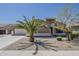 Inviting home featuring desert landscaping, a charming facade, and a well-maintained front yard with mature palm at 15655 W Berkeley Rd, Goodyear, AZ 85395
