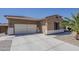 Spacious two-car garage, showcasing the home's ample parking and tiled roof at 15655 W Berkeley Rd, Goodyear, AZ 85395