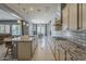 Modern kitchen with a large island, granite countertops, stainless steel appliances, and ample counter space at 15655 W Berkeley Rd, Goodyear, AZ 85395