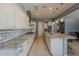 Well-appointed kitchen with a large island, stainless steel appliances, and views into the adjacent dining and living spaces at 15655 W Berkeley Rd, Goodyear, AZ 85395