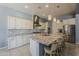 Bright and airy kitchen with a large island, granite countertops, subway tile backsplash, and modern appliances at 15655 W Berkeley Rd, Goodyear, AZ 85395
