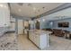 Elegant kitchen with a granite island, stainless steel appliances, open layout, and views into the living area at 15655 W Berkeley Rd, Goodyear, AZ 85395