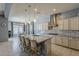 Beautiful kitchen with a large island, stainless steel appliances, pendant lights, and a breakfast bar with seating at 15655 W Berkeley Rd, Goodyear, AZ 85395