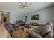 This living room offers a sectional, TV, tile flooring, and neutral paint at 15655 W Berkeley Rd, Goodyear, AZ 85395