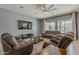 The living room includes a large sectional and TV and tile flooring at 15655 W Berkeley Rd, Goodyear, AZ 85395