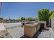 Outdoor kitchen with built-in grill and sink near a swimming pool, basketball court, and manicured backyard at 15655 W Berkeley Rd, Goodyear, AZ 85395