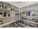 Organized walk-in pantry with ample shelving for storage at 15655 W Berkeley Rd, Goodyear, AZ 85395