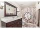 Bathroom features a wood vanity, large mirror, and a bathtub with a decorative Easter-themed shower curtain at 15825 N 45Th St, Phoenix, AZ 85032