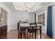 Open dining room featuring hardwood floors, modern chandelier, and a window at 15825 N 45Th St, Phoenix, AZ 85032
