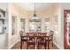 Elegant dining room with bay window, chandelier, and wood floors offers views of the backyard pool at 15825 N 45Th St, Phoenix, AZ 85032