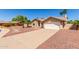 Inviting single-story home featuring desert landscaping, a long driveway, and a two-car garage at 15825 N 45Th St, Phoenix, AZ 85032