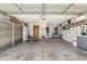 Spacious garage features ample storage cabinets, a refrigerator, and plenty of open space for parking and projects at 15825 N 45Th St, Phoenix, AZ 85032