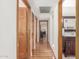 A wood floored hallway leading to the bathrooms and bedrooms provides a sense of continuity at 15825 N 45Th St, Phoenix, AZ 85032
