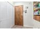Hallway featuring a closet with bifold doors and a storage unit with shelves and a wicker basket at 15825 N 45Th St, Phoenix, AZ 85032
