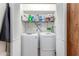 Closet laundry room features a side-by-side washing machine and dryer with a shelf above for storage at 15825 N 45Th St, Phoenix, AZ 85032