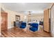 Stylish main bedroom with wood floors, ample closet space, and a sitting area with plush blue chairs at 15825 N 45Th St, Phoenix, AZ 85032