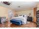 Main bedroom with decorative walls, wood floors, an ensuite bathroom, and a king size bed at 15825 N 45Th St, Phoenix, AZ 85032
