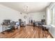 Spacious home office with hardwood floors, chandelier, and an abundance of natural light at 15825 N 45Th St, Phoenix, AZ 85032