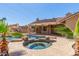Backyard oasis featuring a pool and spa with solar panels, perfect for relaxation and energy efficiency at 15825 N 45Th St, Phoenix, AZ 85032