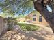 Shaded backyard showcasing lush landscaping and an extended patio at 16661 W Central St, Surprise, AZ 85388