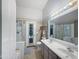 Well-lit bathroom featuring a double sink vanity, tiled floors, shower, and tub, providing a relaxing space at 16661 W Central St, Surprise, AZ 85388