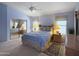 Bright and spacious main bedroom featuring a ceiling fan, carpet, blinds, and a sliding mirror door closet at 16661 W Central St, Surprise, AZ 85388
