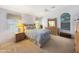 Comfortable main bedroom with plush carpet, a ceiling fan, dresser, and abundant natural light from large windows at 16661 W Central St, Surprise, AZ 85388
