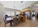 Eat-in kitchen featuring stainless steel appliances, wood cabinetry, a breakfast bar, and a view of living area at 16661 W Central St, Surprise, AZ 85388