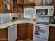 Well-lit kitchen featuring wooden cabinets, sleek countertops and white appliances at 17200 W Bell Rd # 1279, Surprise, AZ 85374