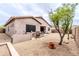Expansive backyard with desert landscaping, a covered patio, a built in BBQ, and a well-maintained exterior at 18633 W Mcneil St, Goodyear, AZ 85338