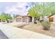This beautiful home features a three-car garage, desert landscaping, and a spacious driveway at 18633 W Mcneil St, Goodyear, AZ 85338