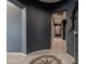 Elegant hallway with designer touches, tile floors, and warm lighting that leads to the main rooms at 18633 W Mcneil St, Goodyear, AZ 85338