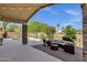 Inviting outdoor patio with comfortable seating and views of the lush backyard and pool at 20239 N 39Th Dr, Glendale, AZ 85308