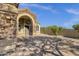Beautiful home exterior with stone accents, arched entryway, and a well-maintained yard at 20239 N 39Th Dr, Glendale, AZ 85308