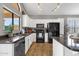 Well-lit kitchen with stainless steel appliances, white cabinets, and sleek countertops at 20239 N 39Th Dr, Glendale, AZ 85308