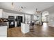 Bright open kitchen with an island, modern appliances, wood floors and an open view to the living room at 20239 N 39Th Dr, Glendale, AZ 85308