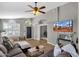 Open-concept living room with plank floors, natural light, and a large sectional sofa at 20239 N 39Th Dr, Glendale, AZ 85308
