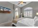 Light-filled main bedroom featuring a television, ensuite bathroom and arched window with shutter at 20239 N 39Th Dr, Glendale, AZ 85308
