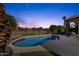 Backyard with a refreshing pool, surrounded by lush landscaping and a covered patio at 20239 N 39Th Dr, Glendale, AZ 85308