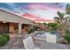 Charming backyard with a pool, patio seating, and desert landscaping at sunset at 2103 E Canyon Pl, Chandler, AZ 85249