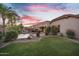 Lush backyard with green lawn, sparkling pool, mature trees, and shaded patio, perfect for outdoor living at 2103 E Canyon Pl, Chandler, AZ 85249
