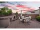 Cozy backyard patio with brick pavers, outdoor fireplace, dining table and chairs, perfect for entertaining at 2103 E Canyon Pl, Chandler, AZ 85249