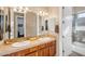 Bathroom featuring a double vanity with tile backsplash and decorative mirrors at 2103 E Canyon Pl, Chandler, AZ 85249